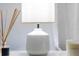 Close up of a white bedside table lamp and reed diffuser at 8940 Rhodes St, Kissimmee, FL 34747