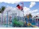 Community water park features a dumping bucket water feature, a slide, and wading pool at 8940 Rhodes St, Kissimmee, FL 34747