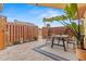 Charming backyard patio featuring a dining set on a cozy rug, complemented by lush greenery and a privacy fence at 90 Cedar Dunes Dr, New Smyrna Beach, FL 32169