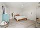 Sunlit bedroom featuring wood floors, a ceiling fan, a large bed, and closet space with decor at 90 Cedar Dunes Dr, New Smyrna Beach, FL 32169