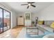 Comfortable living room with terracotta tile flooring, neutral furniture, and sliding glass doors to the outdoor area at 90 Cedar Dunes Dr, New Smyrna Beach, FL 32169