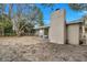 View of the chimney and backyard, ready for new owners' personal touch at 906 Ferndell Rd, Orlando, FL 32808