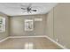 Bright bedroom featuring tile flooring, a ceiling fan, and a large window at 906 Ferndell Rd, Orlando, FL 32808