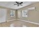 Cozy bedroom with neutral walls, tile floors, and a ceiling fan for comfort at 906 Ferndell Rd, Orlando, FL 32808