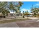 View of the exterior of a home with a well-kept front yard and a clear blue sky at 906 Ferndell Rd, Orlando, FL 32808