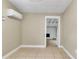 Living room with tile flooring, neutral walls, and an opening to another room at 906 Ferndell Rd, Orlando, FL 32808