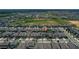 Aerial view of a neighborhood featuring well-maintained homes, green spaces, and community amenities at 9180 Carmela Ave, Davenport, FL 33897