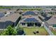 Aerial view of a backyard with solar panels, a trampoline, seating, and a white fence at 9180 Carmela Ave, Davenport, FL 33897