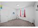 Simple bedroom with a window, carpeting, and a door, offering a blank canvas for personalization at 9180 Carmela Ave, Davenport, FL 33897