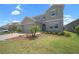 Charming two-story home featuring a two-car garage, manicured lawn, and decorative landscaping at 9180 Carmela Ave, Davenport, FL 33897