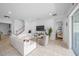 Bright, open-concept living room featuring tile floors, modern furniture, and a sliding glass door at 9180 Carmela Ave, Davenport, FL 33897