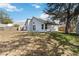 Backyard view showcases a spacious green lawn, shed, and blue skies at 9307 Echo Run, Orlando, FL 32817