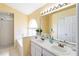 Well-lit bathroom features double sink vanity and walk-in shower at 9307 Echo Run, Orlando, FL 32817