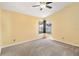 Neutral bedroom boasts large window and ceiling fan at 9307 Echo Run, Orlando, FL 32817