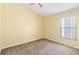 Spacious carpeted bedroom features a ceiling fan and natural light from the window at 9307 Echo Run, Orlando, FL 32817