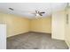 Carpeted bonus room with ceiling fan, neutral paint, and functional layout at 9307 Echo Run, Orlando, FL 32817