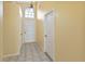 Inviting entryway with tile flooring, a transom window, and neutral paint at 9307 Echo Run, Orlando, FL 32817