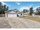 A charming single-story home with an attached two-car garage on a sunny day at 9307 Echo Run, Orlando, FL 32817