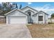 Single story home with a two-car garage, arched entryway and neatly kept yard at 9307 Echo Run, Orlando, FL 32817