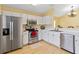 Well-lit kitchen with stainless steel appliances, white cabinets and breakfast bar at 9307 Echo Run, Orlando, FL 32817