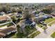 Aerial view of a home featuring solar panels, surrounded by a peaceful neighborhood setting with mature trees at 9544 Brimton Dr, Orlando, FL 32817