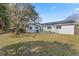 A wide backyard with a patio, a barbecue grill, and solar panels above a well-maintained lawn at 9544 Brimton Dr, Orlando, FL 32817