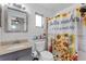 Bright bathroom with a sunflower shower curtain, granite countertop, and decorative mirror at 9544 Brimton Dr, Orlando, FL 32817