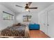 Bedroom with laminate wood flooring, ceiling fan, and a blue accent dresser at 9544 Brimton Dr, Orlando, FL 32817