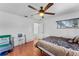 Bedroom with laminate wood flooring, ceiling fan, a closet, and neutral colored walls at 9544 Brimton Dr, Orlando, FL 32817