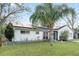 Attractive single-story home featuring a palm tree and solar panels for energy efficiency at 9544 Brimton Dr, Orlando, FL 32817