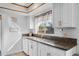 Kitchen area featuring stainless steel sink, granite counters, and a view of the front yard at 9544 Brimton Dr, Orlando, FL 32817