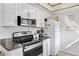 Kitchen featuring stainless steel range, microwave, and refrigerator along with granite counters at 9544 Brimton Dr, Orlando, FL 32817