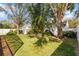 Spacious backyard with lush green grass and mature trees and shrubbery at 9848 Nonacrest Dr, Orlando, FL 32832