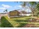 The backyard features a bird bath, expansive green grass, and an in-ground pool at 9848 Nonacrest Dr, Orlando, FL 32832