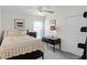 Well-lit bedroom featuring a ceiling fan, large window, and full-sized bed with side desk at 9848 Nonacrest Dr, Orlando, FL 32832