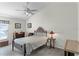 Simple bedroom with neutral walls, ceiling fan, and classic wood furniture at 9848 Nonacrest Dr, Orlando, FL 32832