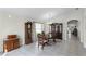 Warm dining area with wooden table set, complemented by a wooden hutch and neutral decor at 9848 Nonacrest Dr, Orlando, FL 32832