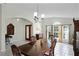 Elegant dining room featuring a large wooden table set and a window providing natural light at 9848 Nonacrest Dr, Orlando, FL 32832