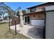 Paver patio outside with closed beige umbrella and neutral colored home at 1104 Southampton Dr # 3, Port Orange, FL 32129