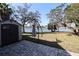 Spacious backyard with a shed, waterfront views, and an umbrella stand, perfect for outdoor enjoyment at 1104 Southampton Dr # 3, Port Orange, FL 32129