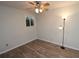 Cozy bedroom with wood-look floors, neutral walls, and a ceiling fan with overhead lighting at 1104 Southampton Dr # 3, Port Orange, FL 32129