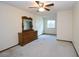 Spacious bedroom featuring a ceiling fan, neutral carpet, and a classic wood dresser at 1104 Southampton Dr # 3, Port Orange, FL 32129