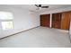 Bedroom featuring neutral color palette, ceiling fan, large window, and multiple closets at 1104 Southampton Dr # 3, Port Orange, FL 32129