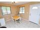 Bright dining area with neutral walls, tiled flooring, and a wooden table set with seating for four at 1104 Southampton Dr # 3, Port Orange, FL 32129