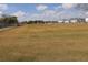 Large grassy community field near blue townhomes and neighborhood amenities at 1104 Southampton Dr # 3, Port Orange, FL 32129