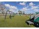 Playground with swings, slide, and climbing structure under a blue sky at 1104 Southampton Dr # 3, Port Orange, FL 32129