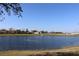 Exterior view of community pond with fountain in the distance against blue skies at 1104 Southampton Dr # 3, Port Orange, FL 32129