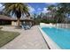 Inviting community pool area featuring a palm tree, seating, and ample space for relaxation and recreation at 1104 Southampton Dr # 3, Port Orange, FL 32129