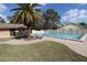 Community pool and patio with ample seating, offering a refreshing oasis for relaxation and social gatherings at 1104 Southampton Dr # 3, Port Orange, FL 32129