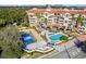 Aerial view of condo featuring a pool, tennis court, and beautiful landscaping at 1110 W Ivanhoe Blvd # 5, Orlando, FL 32804